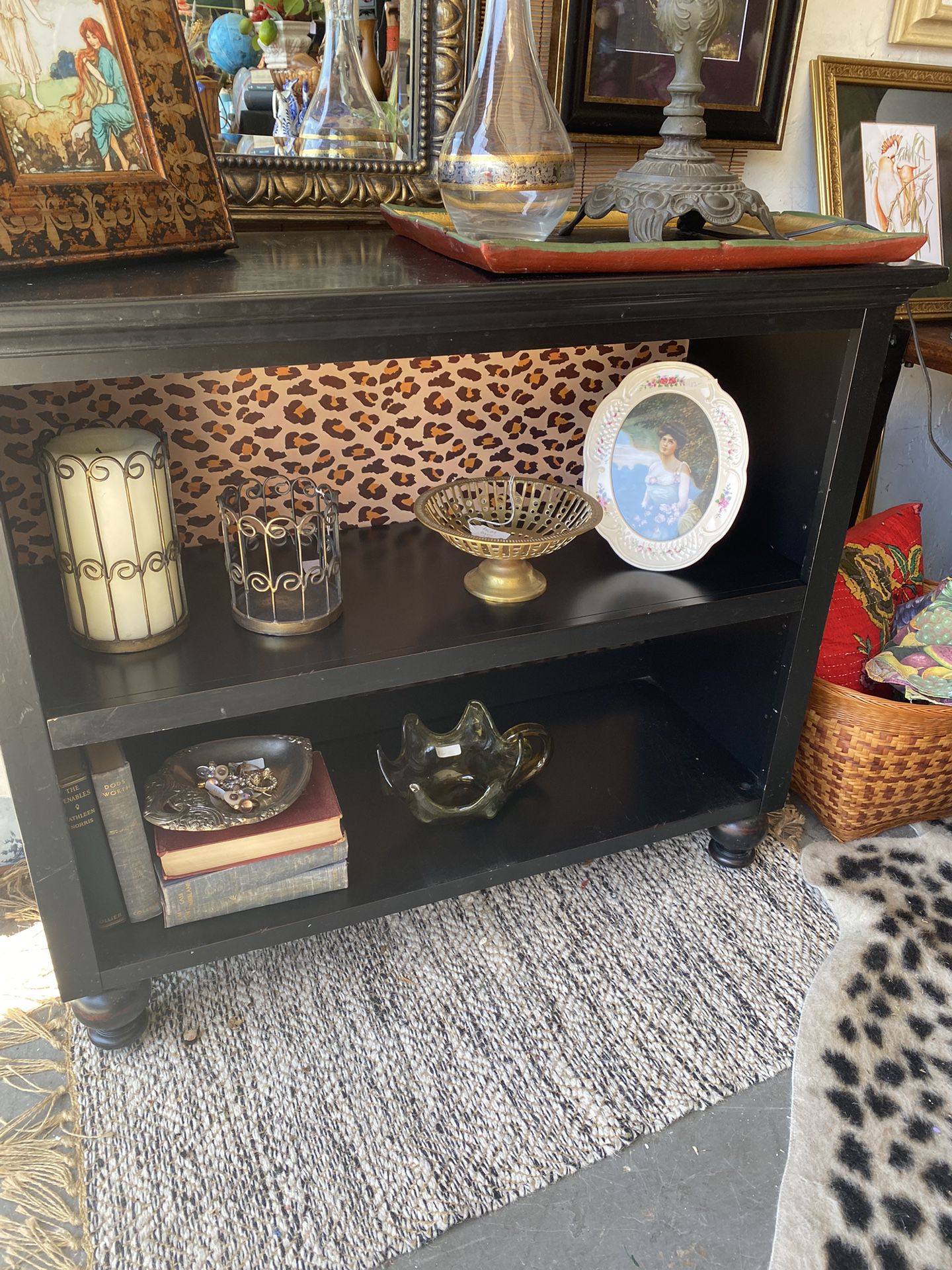 small black bookshelf or tv stand, leopard print back, adjustable shelf