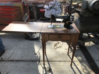 Old Singer Sewing Machine With Cabinet And A Chair