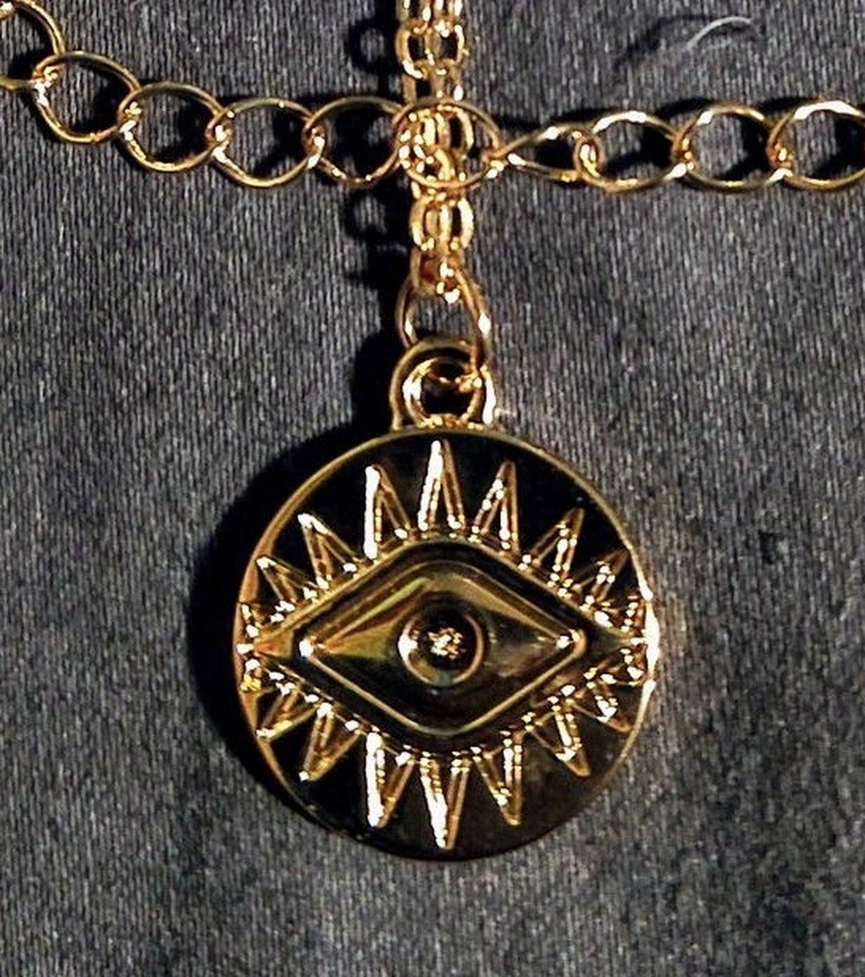 Little gold tone Evil Eye charm for warding off bad juju :)