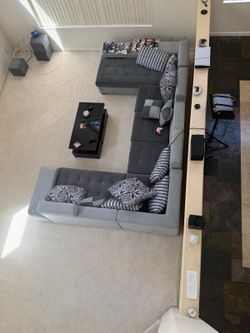 Gray sectional with small seats and cubby holes