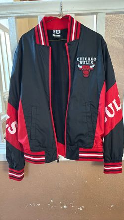 This is a black and red Chicago Bulls full-zip track jacket. 