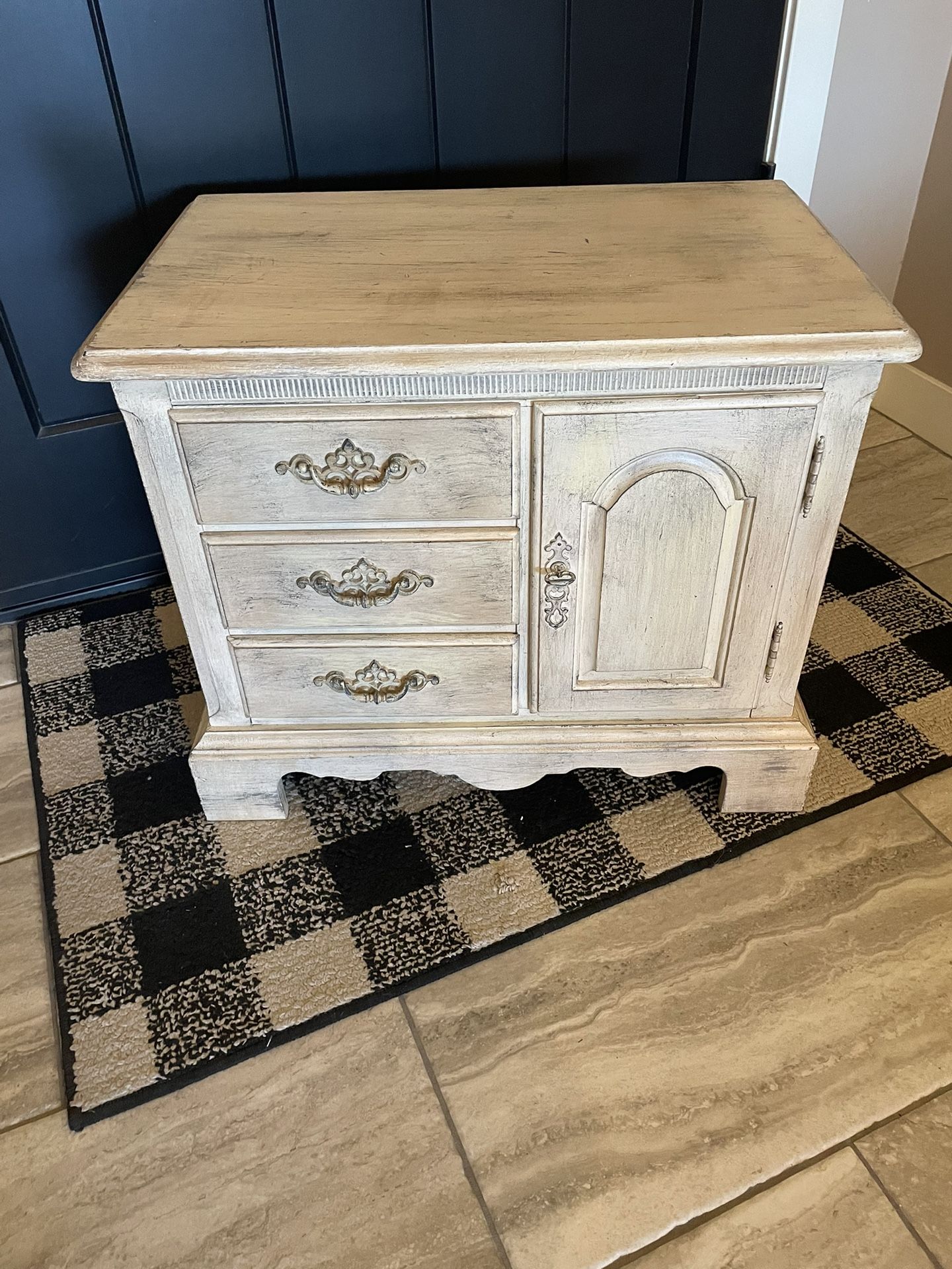 Side table with three drawers and a door for storage