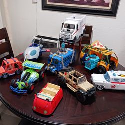 selling all these cars  
- WWE ambulance
- Ghostbusters car, missing one side door
- Turtle Ninjas car
- Fortnite blue bus
- P. J. Mask ship
- Bluey o