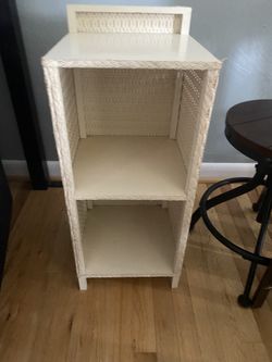 white wicker 2-tier shelving unit