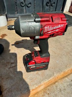 Milwaukee impact wrench with charger and 12V battery