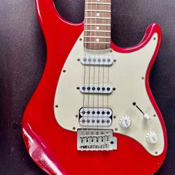  The 1990s Peavey Raptor Plus EXP Electric Guitar is a vintage right-handed electric guitar with a solid red body, featuring a maple neck and rosewood