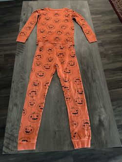 two-piece pajama set featuring an all-over jack-o'-lantern pumpkin print. Size 8