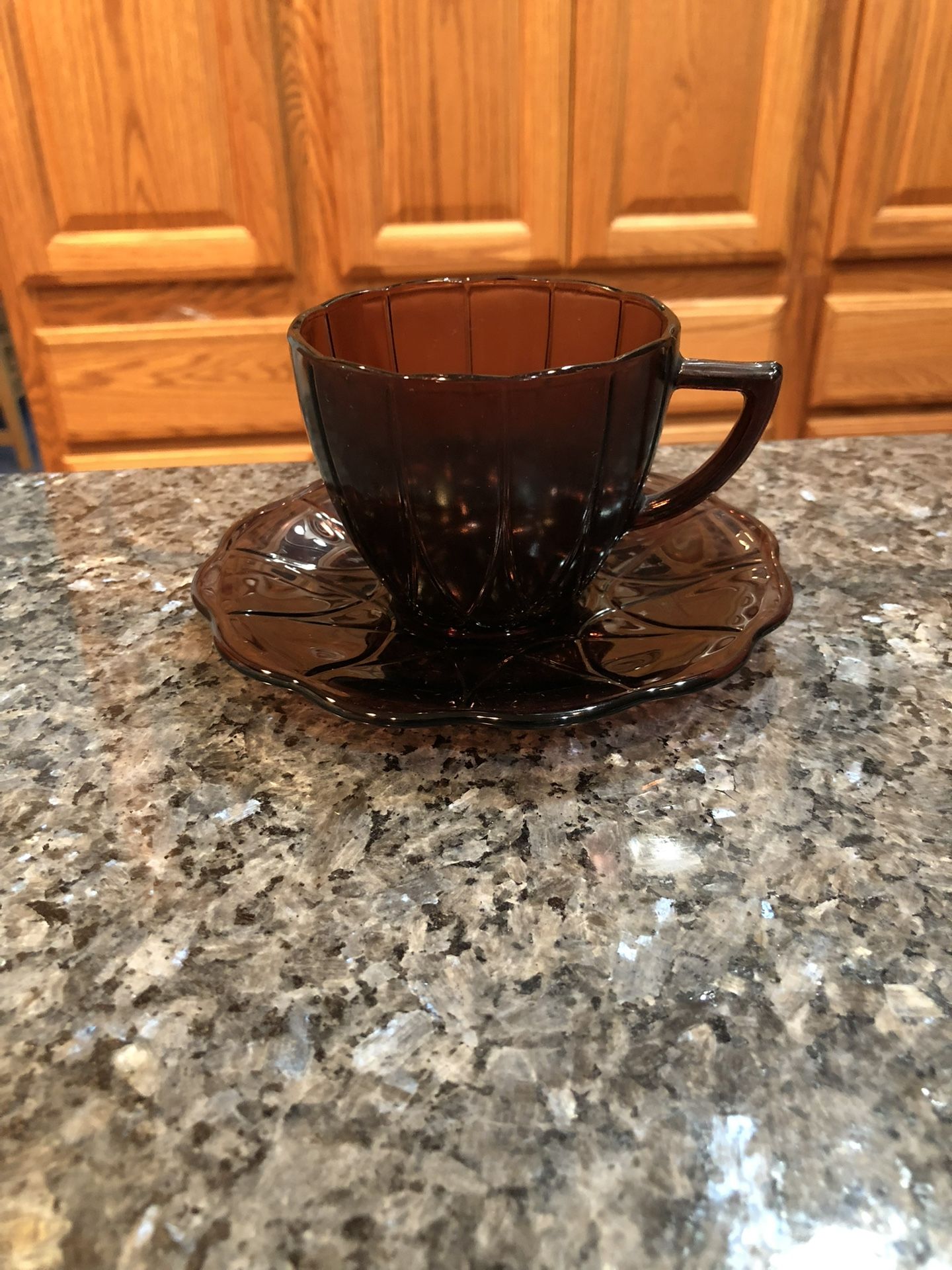 Vintage Pretty Hazel Atlas Newport Amethyst Depression Glass Cup and saucer .  Saucer Size 3 1/4 inches Tall .  Size of Cup. 2 3/4 inches tall and 3 1