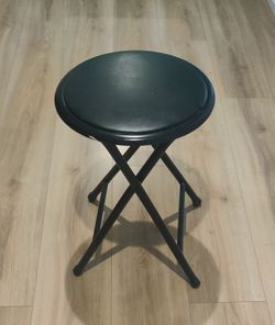 Black folding stool (chair)