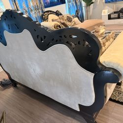 “Luxury Baroque / Rococo style living room set with ornate carved wood frame, black and gold accents, velvet upholstery, and matching chaise lounge.”