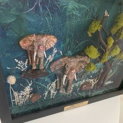 Very unique 1 of a kind 3-D effect beautiful hand sculpted and hand painted mother and baby elephant enclosed in a very expensive shadow box.   Set in