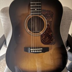 Guild Acoustic Guitar with Hard Shell Case.