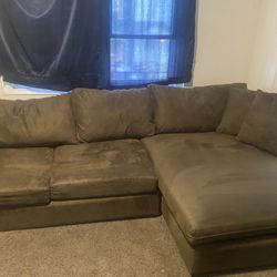 Sectional suede couch with cushions used clean