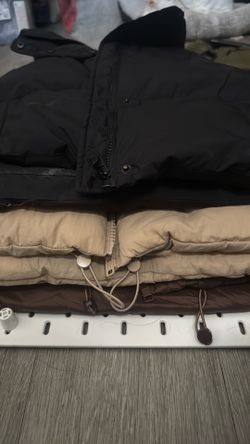 Sleeveless puff jackets sold together