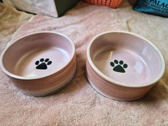 Two small dog bowls and a dog puzzle game