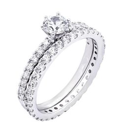 Two-piece wedding set features an engagement ring with 5mm (0.5 carat) round brilliant cut Infinite Elements Cubic Zirconia. 925 sterling silver.