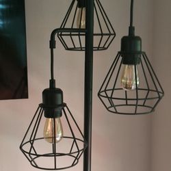 This is a York Industrial Tree Floor Lamp with black metal cage shades. Bulbs included   open box