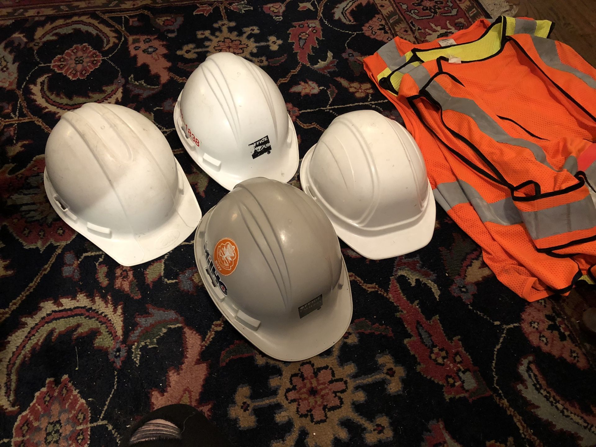 Four Hard Hats and Three Safety Vests