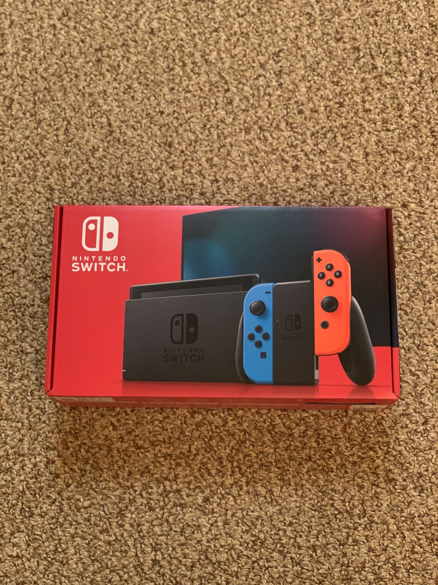 New Nintendo Switch V2 32 GB Neon Blue Red in hand