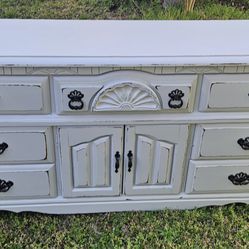 Distressed White Solid Wood Dresser. Black Hardware. 7 Drawers. 18 inches deep by 68 inches long by 33 inches high