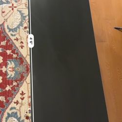 black console / entry table with shelf (looks like IKEA style, about 4.5 ft long).