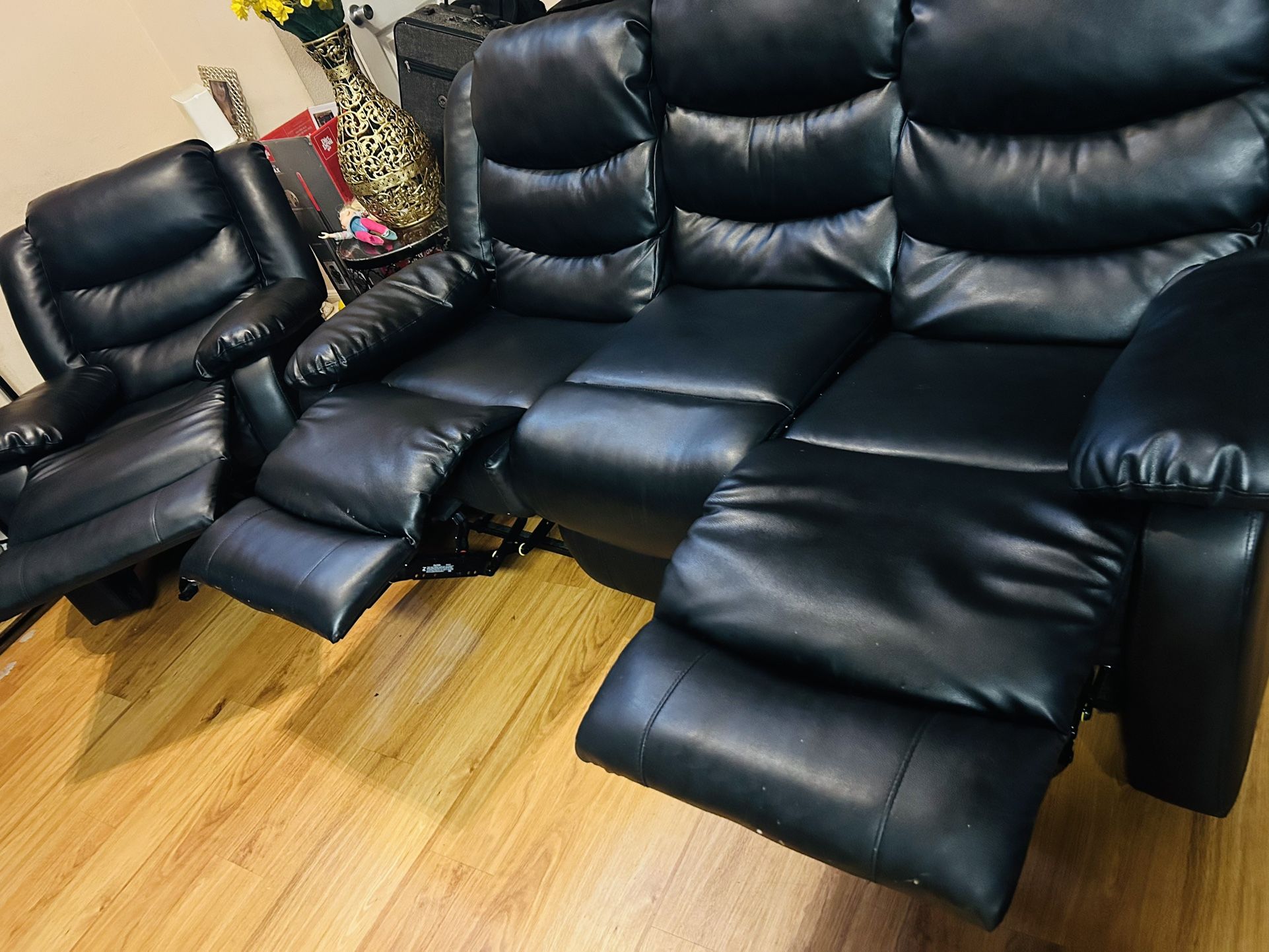 two pieces of black leather recliners