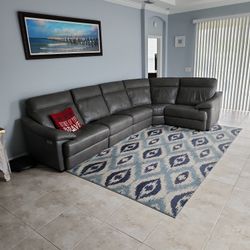 Leather Sectional With Two Recliners On Each Side.