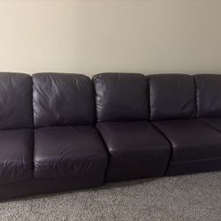 Nearly new purple leather couch