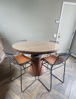 Crate & Barrel Revolve Adjustable Height Dining Table paired with industrial metal and leather counter stools