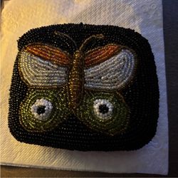 Vintage Elegant beaded coin purse  with a butterfly design.:  black, orange, white, and green glass beads .  Zip Closure  Satin Like Inside Lining  12