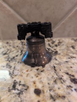 intage bronze or copper-tone replica of the Liberty Bell,