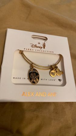 Disney Parks Collection x Alex and Ani Haunted Mansion 50th Anniversary Hitchhiking Ghost bracelet, featuring a gold-tone expandable bangle and an ena