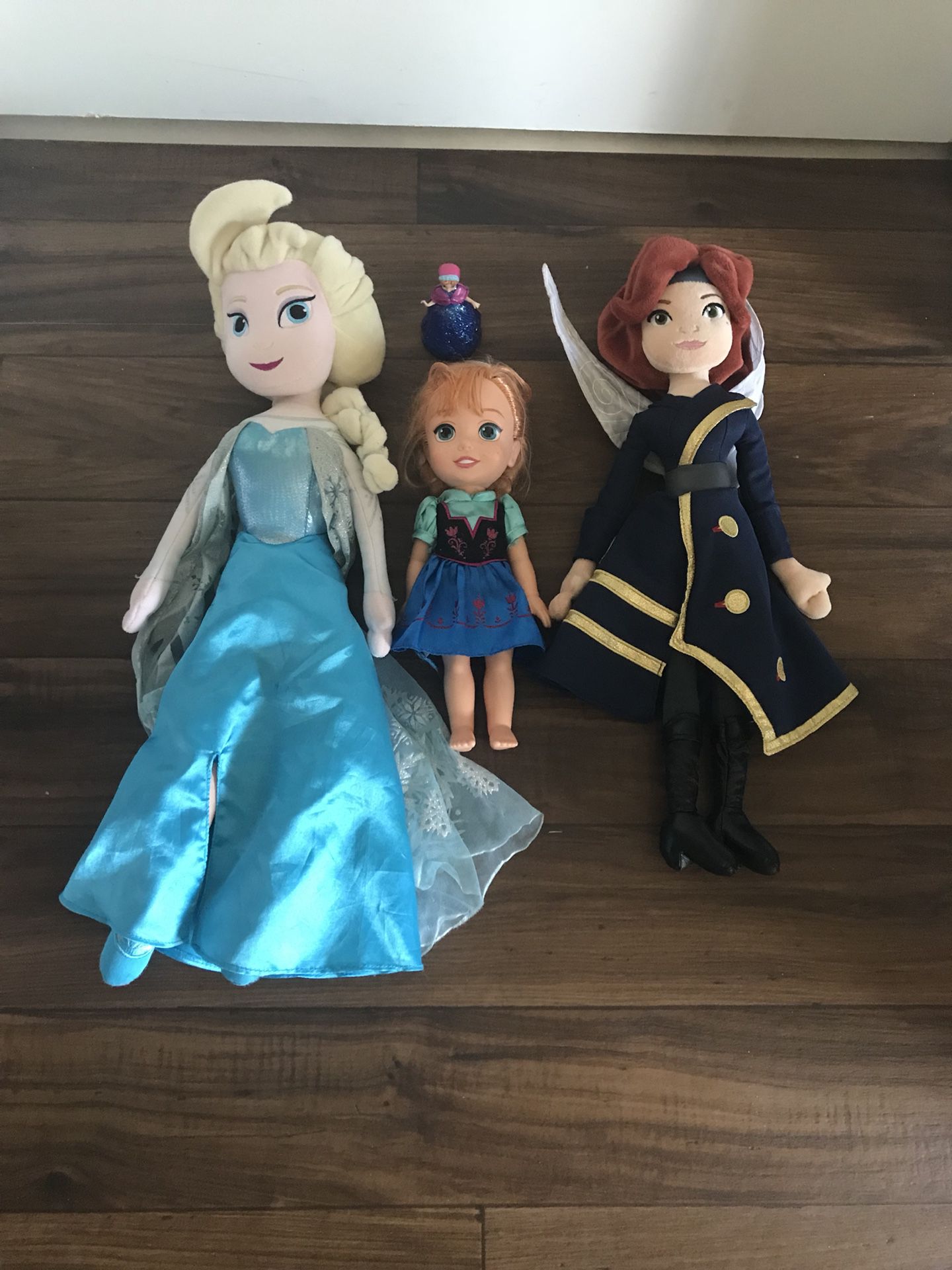 Queen Elsa, Princess Anna and flying fairy from tinker Bell the movie.