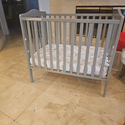 Small Gray baby crib.