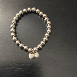 Silver Bead Bracelet With A White Charm