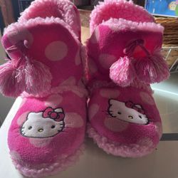 Cozy pink slippers with Hello Kitty design and tassels. Sizes 8 