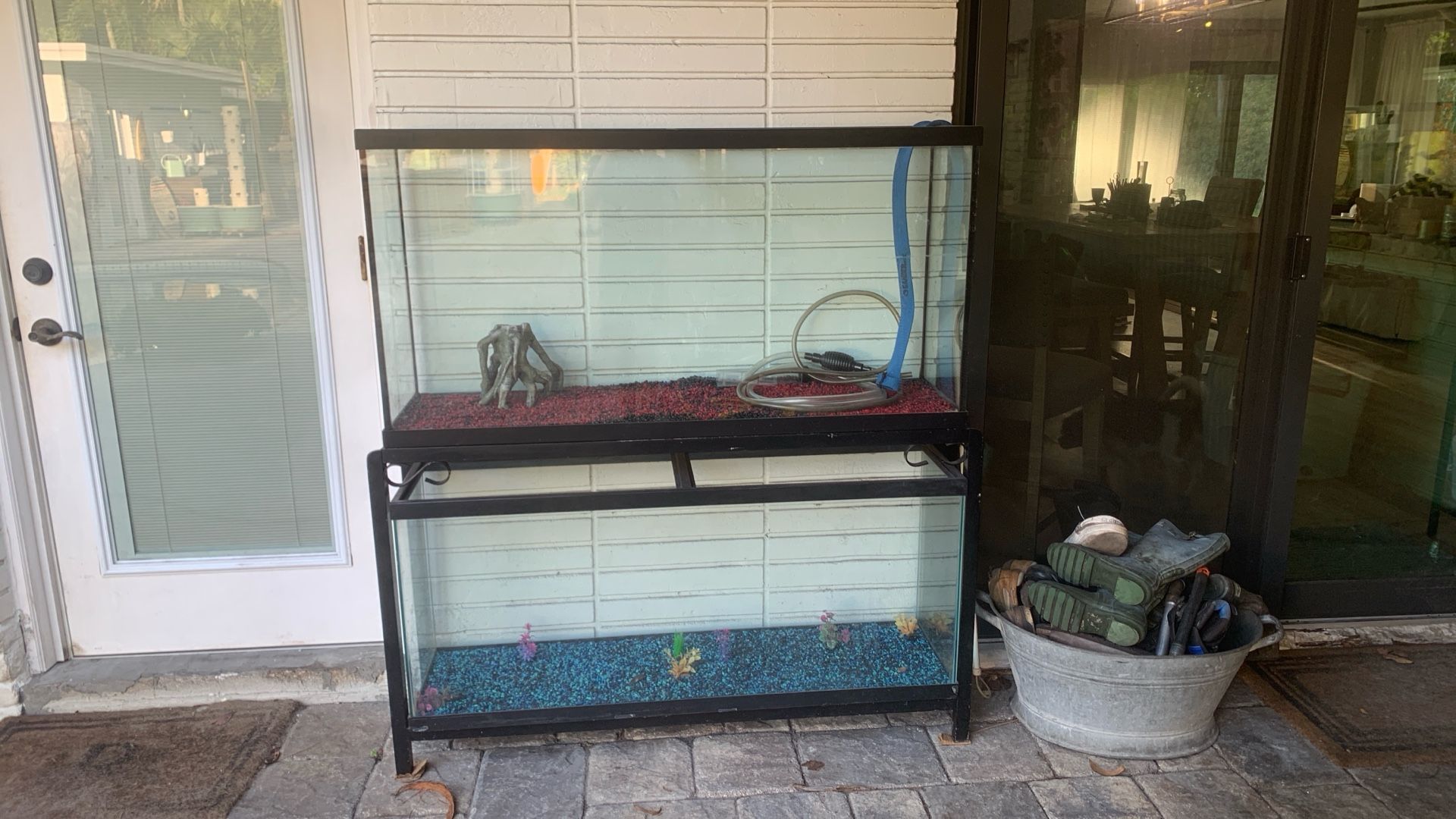 2 fish tanks stand rocks and decorations