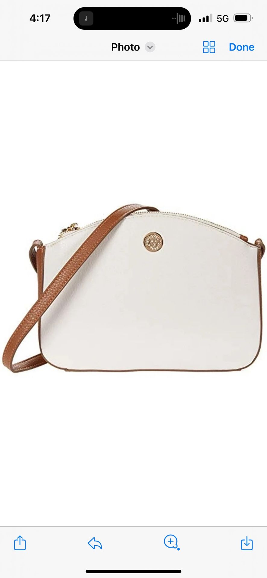 This sophisticated Anne Klein crossbody bag is a stylish and practical accessory for any occasion. Designed with a crisp white body and tan accents, i