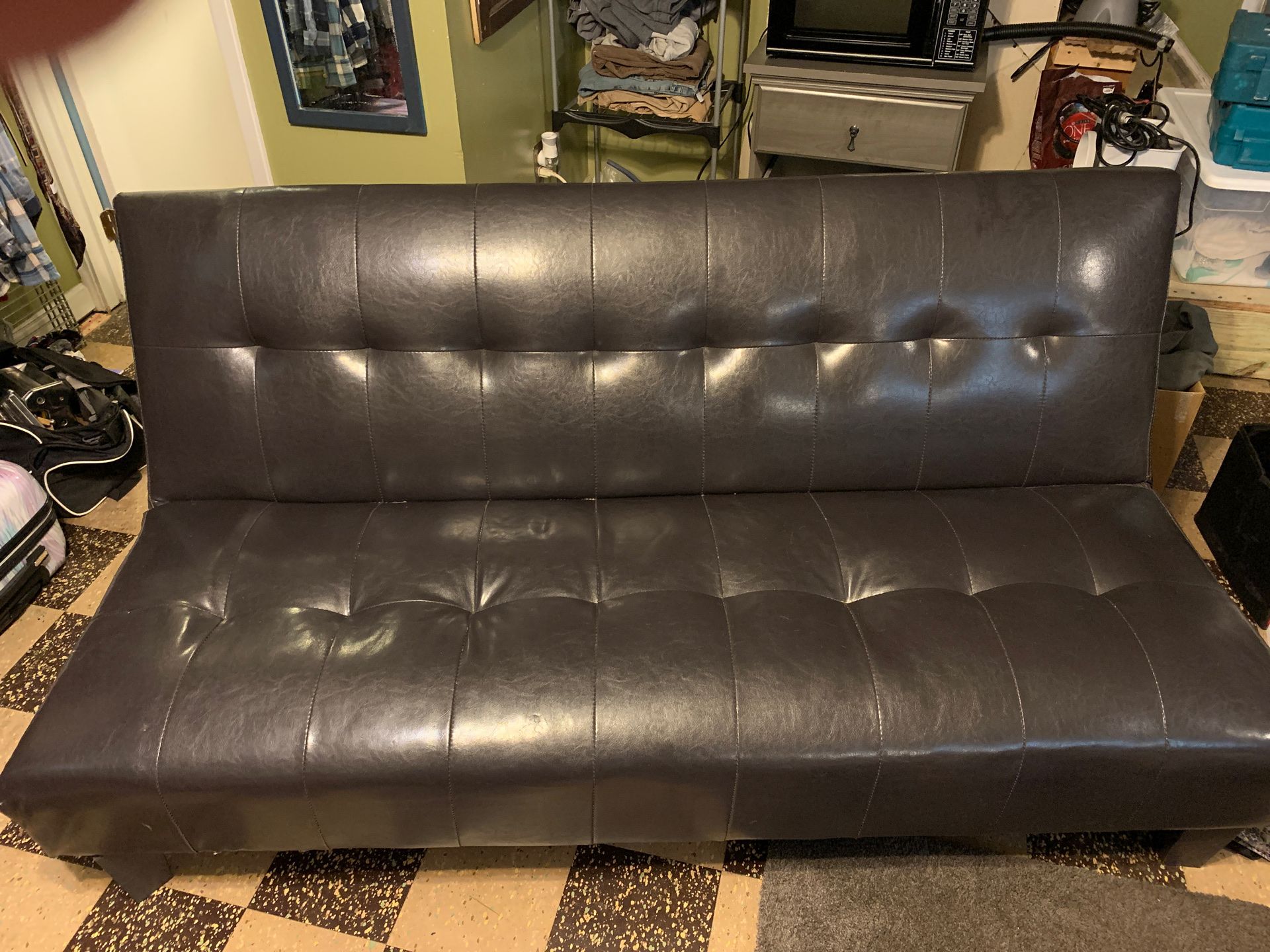 Blackish brown leather futon that’s in mint condition.