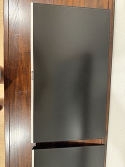 Two computer monitors with articulating arm mounts