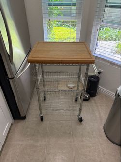 Bamboo cutting board on metal cart