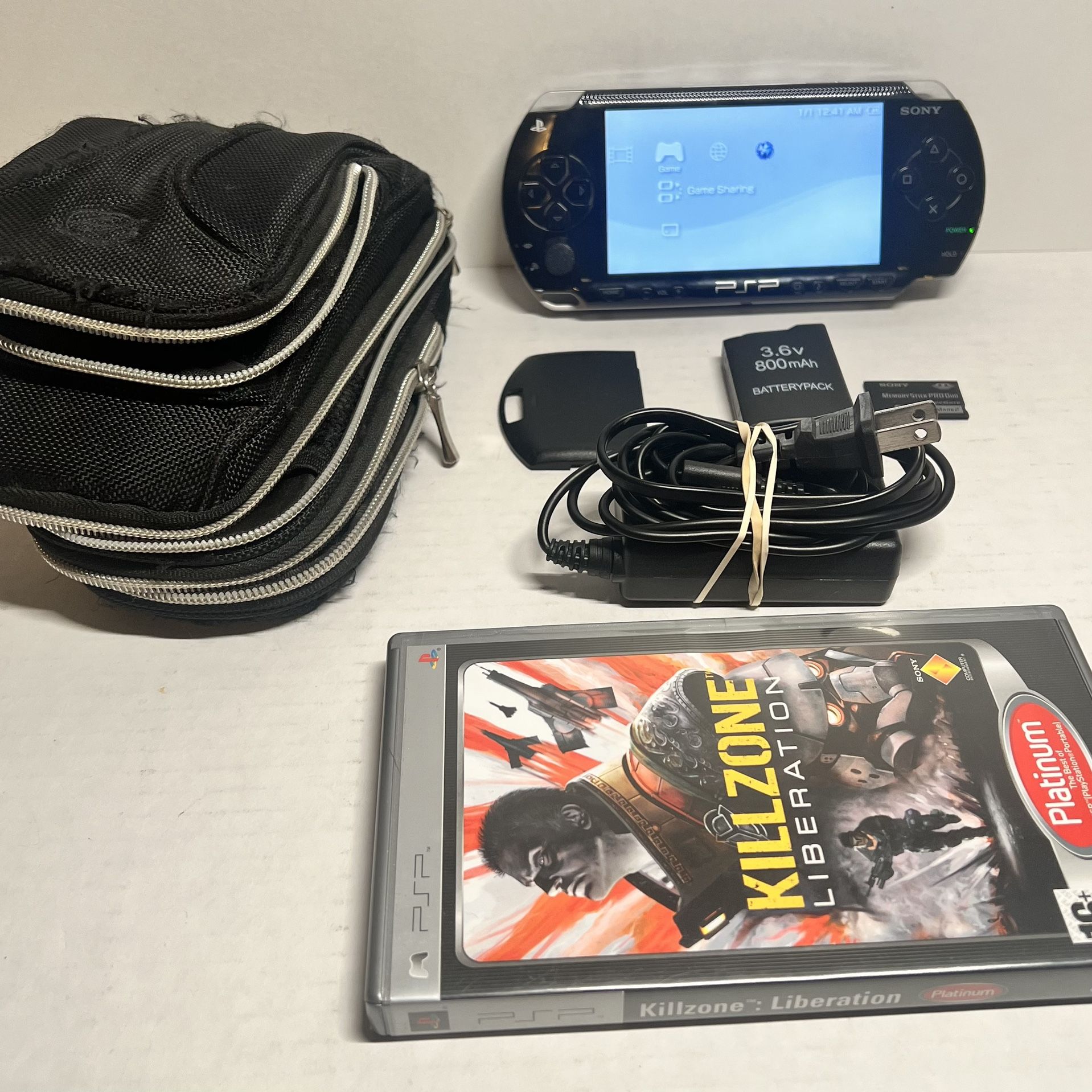 PSP 1000 + original 2GB Memory card + Extra battery / back plate + carrying bag
