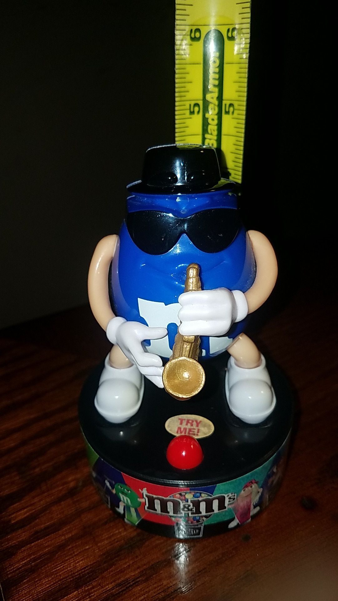 Blue M&M plays a cool saxophone tune when the button is pushed.