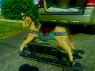 Real antique carnival child’s gliding horse