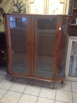 Antique curio display cabinet with curved glass, three shelves and lock and key