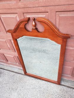 Large beveled glass mirror in carved wood frame