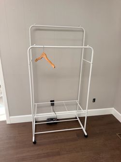 One white aluminum clothing rolling rack