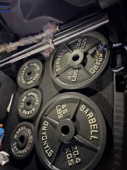 Very nice looking Brand new 45, 35, 25,10, and 5 lb Olympic weight plates and brand new Olympic bars