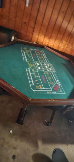 Poker table Versatile octagon game table set includes a reversible top and two matching rolling chairs. The wooden table features a dining surface on 