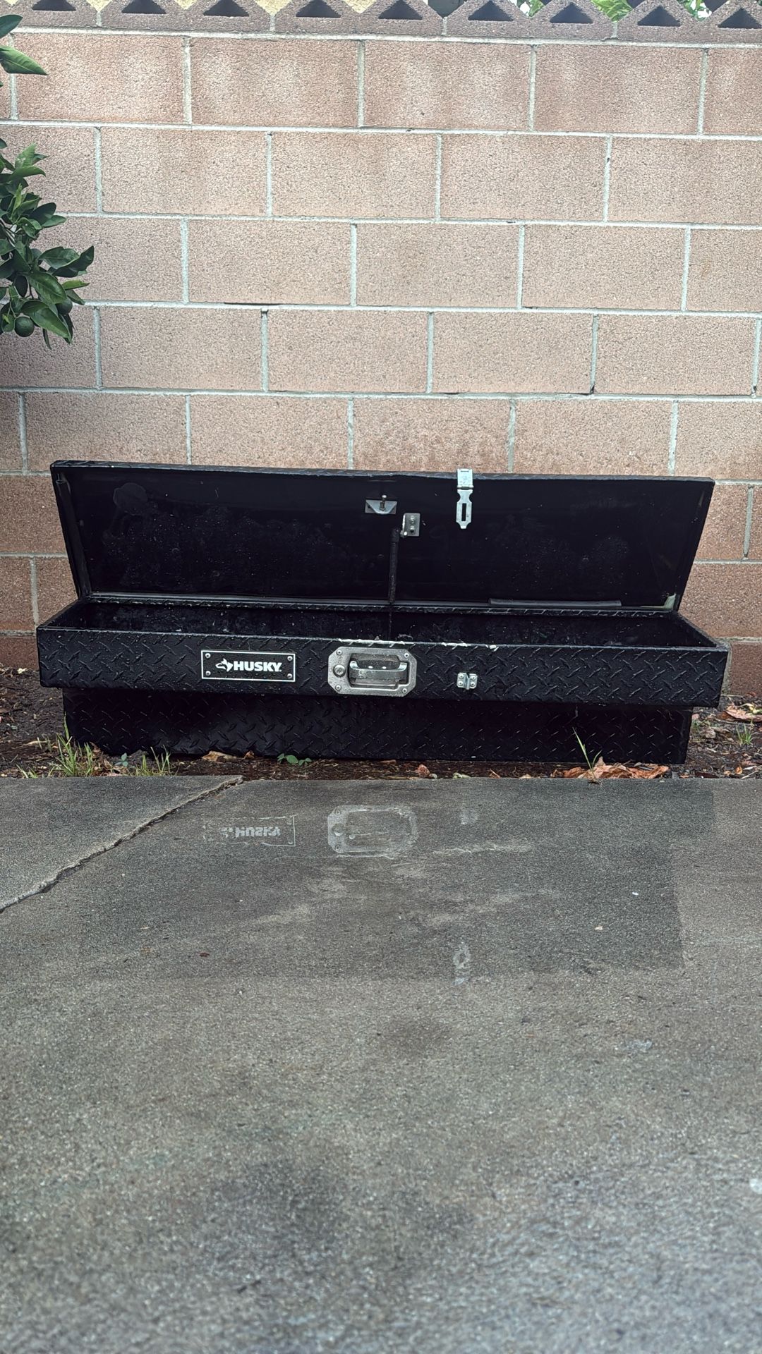 A Black Husky Aluminum Tool Box
